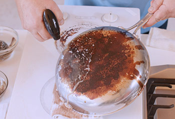 Spraying onto a dirty pan